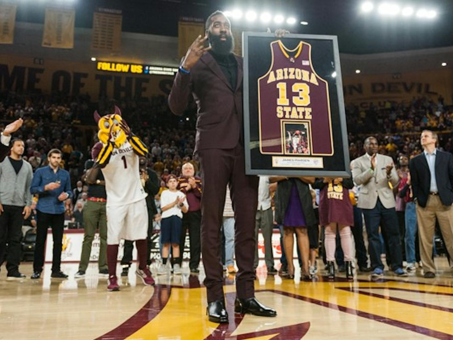 Houston Rockets shooting guard James Harden displays an award on Wednesday, Feb. 18, 2015, at Wells Fargo Arena in Tempe. Harden, a former ASU basketball standout, was honored at halftime for his achievements both with the Sun Devils and in the NBA. (Ben Moffat/The State Press)
