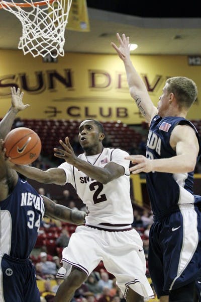 Chris Colvin splits two defenders for a layup against Nevada Dec. 7. Colvin and the Sun Devils look to repeat last season’s sweep of Oregon. (Photo by Sam Rosenbaum)