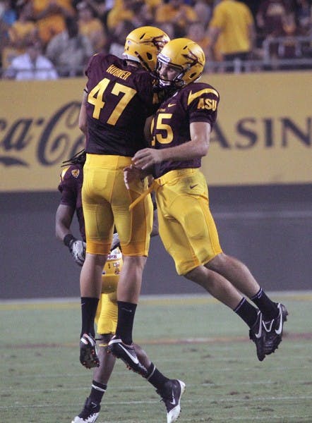 UP IN THE AIR: Redshirt freshman placekicker Alex Garoutte celebrates with junior punter Josh Hubner after Garoutte nailed a 49-yard field goal against UC Davis on Sept. 1. (Photo by Beth Easterbrook)