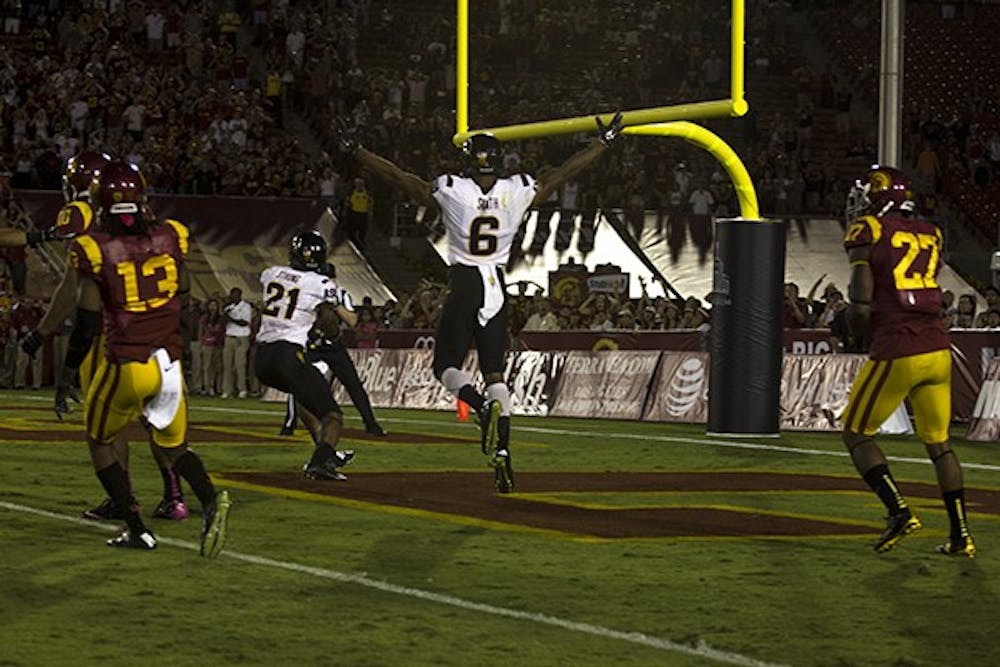Sophomore wide receiver Cameron Smith celebrates as redshirt junior wide receiver Jaelen Strong catches the game winning touchdown against USC on Saturday, Oct. 4, 2014. The Sun Devils beat the Trojans on a Hail Mary as time expired to win 38-34. (Photo by Alexis Macklin)