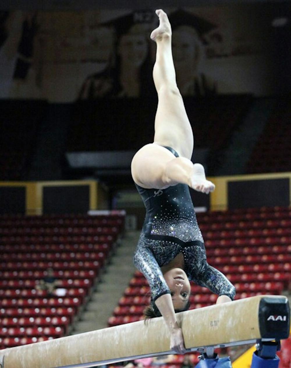 Kahoku Palafox performs a routine on the balance beam in a meet against then-No. 1 Utah on Feb. 12. Palafox was moved into the lineup in the uneven bars and balance beam events after a solid showing against Illinois last weekend. (Photo by Beth Easterbrook)