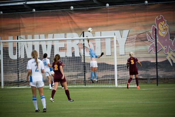 Redshirt junior goalkeeper Chandler Morris reaches to block a goal attempt by UCLA. (Photo by Andrew Ybanez)