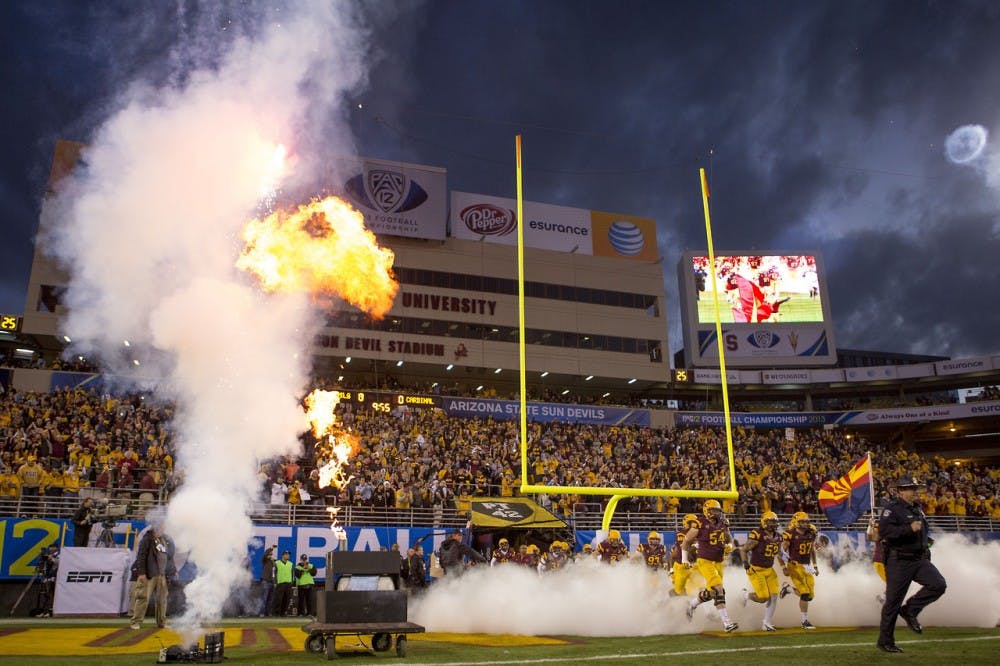 ASU football runs out of the Pat Tillman tunnel before the Pac-12 Championship game, Saturday Dec. 7 2013. (Dominic Valente/ The State Press)
