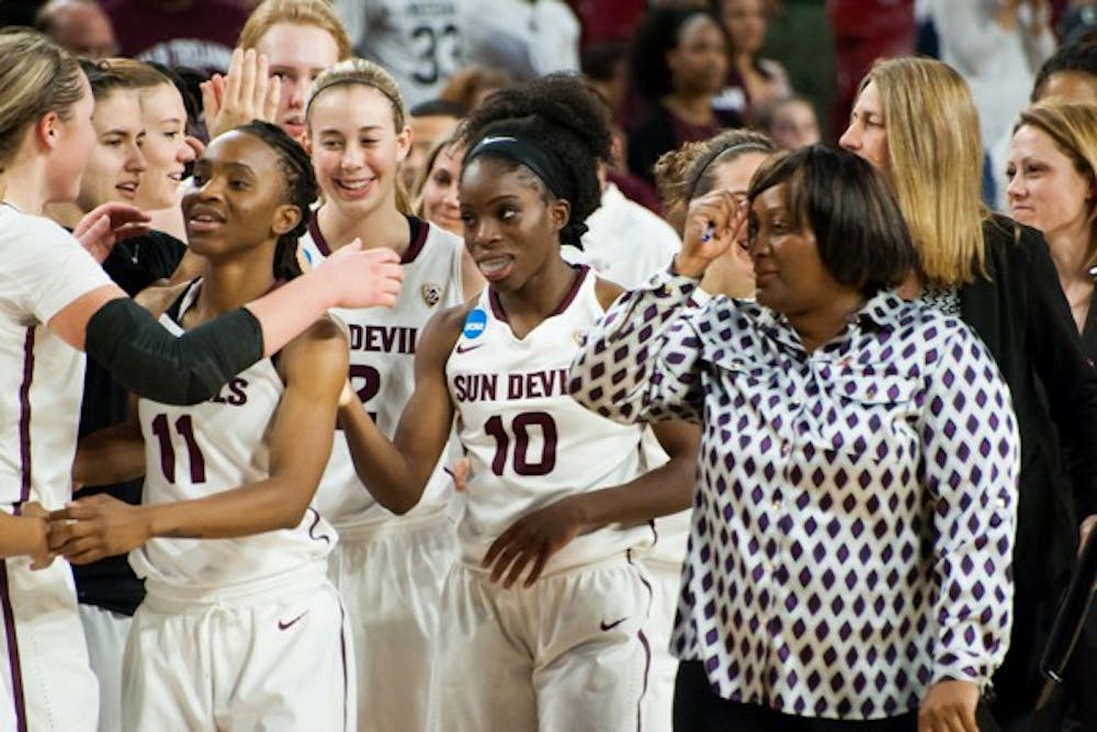 Senior guard Promise Amukamara (center) celebrates with her team after they defeated UALR in the second round of the women's NCAA Tournament on Monday, March 23, 2015, at Wells Fargo Arena in Tempe. The Sun Devils came from behind to defeat the Trojans 57-54 and advance to the Sweet 16. (Ben Moffat/The State Press)