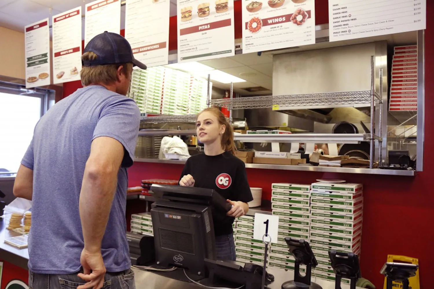 Camp McIntire, a sophomore studying family and human development at ASU, takes a cusotmer’s order at Original Geno’s Pizza in Tempe, Arizona, on Monday, Nov. 7, 2016.