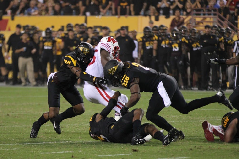 Sophomore wide receiver Richard Smith (bottom) Photo by Diana Lustig