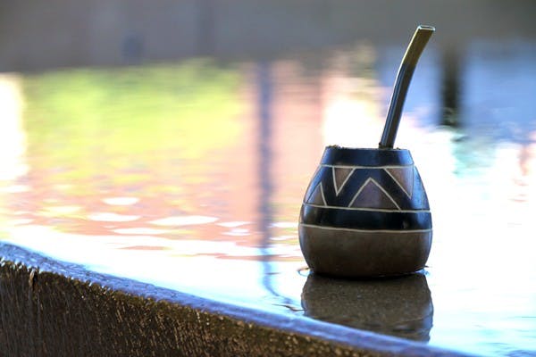 TEA FOUNTAIN - A student cools his maté tea — a South American drink of friendship — in the fountains outside of the W.P Carey School of Business on Wednesday afternoon. (Photo by Rosie Gochnour)