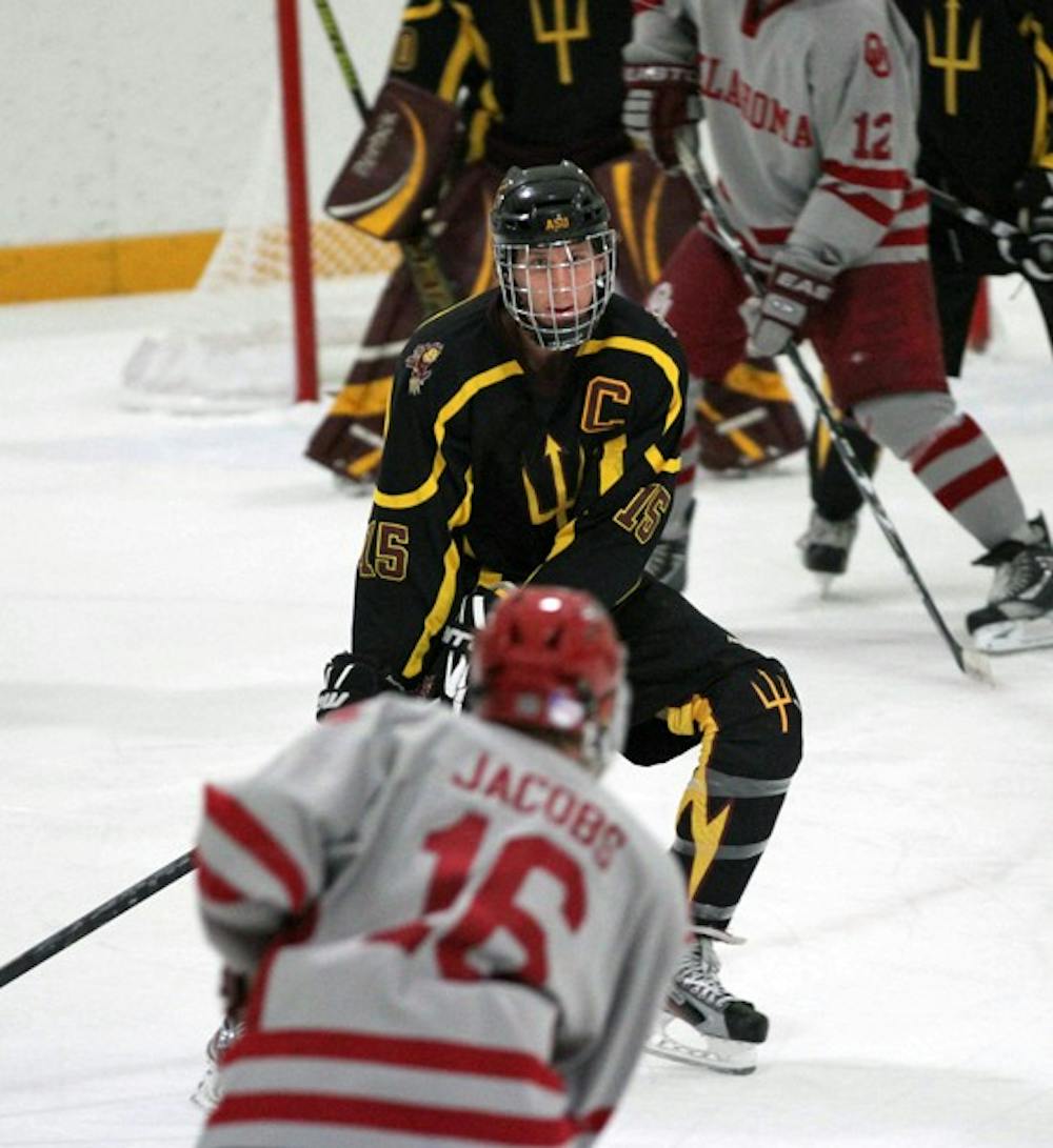 ON THE ICE: Captain Colin Hekle defends Oklahoma sophomore Alex Jacobs during the ASU Club Hockey team’s 6-3 win over the Sooners on Oct. 22. The Sun Devils swept the Sooners for the first time in school history. (Photo by Lisa Bartoli)