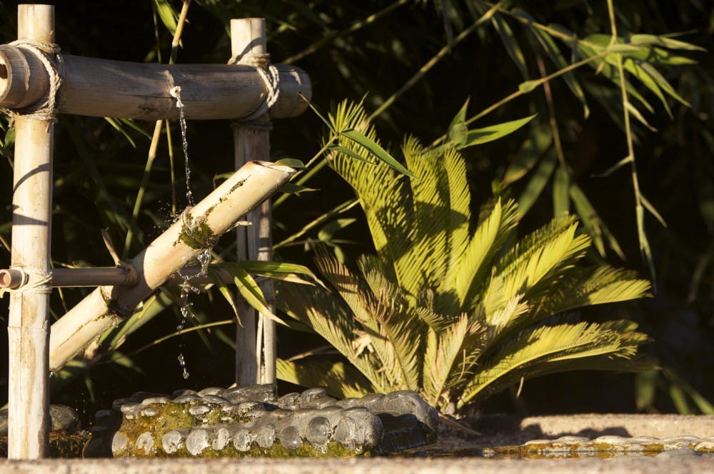 The sun sets on a fountain outside the Language & Literature building Sunday evening. (Photo by Scott Stuk)