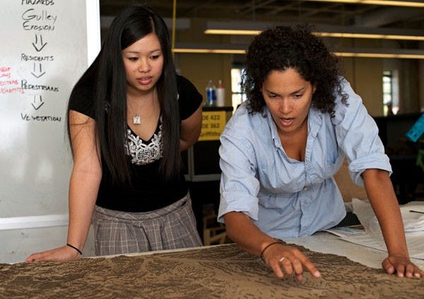 LANDSCAPING: Landscape Architecture majors Kaylee Colter, right, and Trish Nhan explore their topography-model of Nogales, Mexico, created with fellow students in their class. (Photo by Michael Arellano)