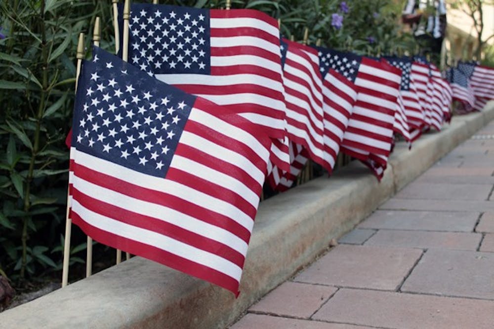 RED, WHITE AND BLUE: Flags line a planter on the Downtown campus in honor of Veterans Day. According to the signs around the flags they represented the 137 Arizona men and women who gave their lives in service since Sept. 11, 2001. (Photo by Beth Easterbrook)
