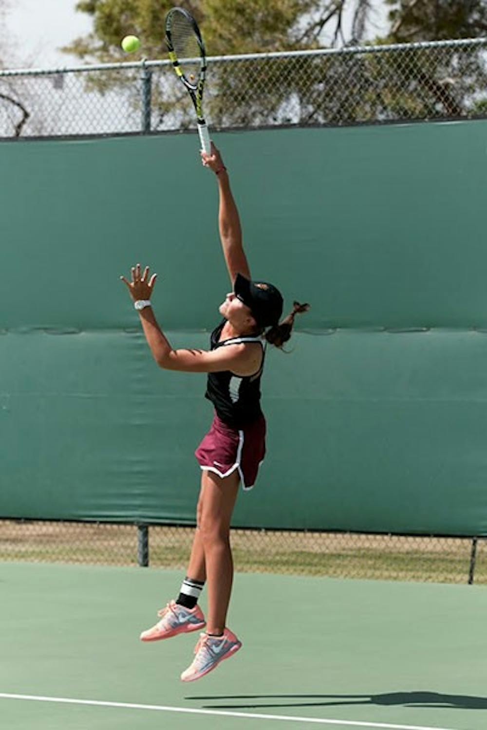 Sophomore Ebony Panoho serves the ball to Colorado junior Ashley Tiefel in a match on April 4. (Photo by Mario Mendez) 