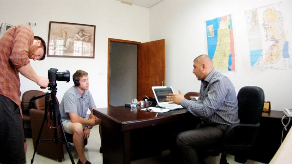 GLOBE TROTTERS: Caleb Barclay, left, and Bill Taggart, middle, set up for an interview with a Palestine News Network executive on Sept. 11. Barclay and Taggart are the Founder and Vice President respectively of a non-profit, grass-roots organization called Peace Frame. (Photo courtesy of Caleb Barclay)