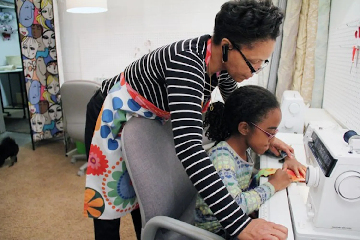 Tina Eaves, owner of the newly opened 1st Stitch downtown sewing lounge, teaches student Grace Williams how to make a headband Wednesday night. (Photo by Diana Lustig)
