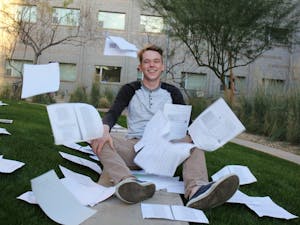 Freshman engineering student Collin Friedrich poses for a photo&nbsp;throwing wasted paper on Barrett lawn on ASU's Tempe, Arizona campus&nbsp;on Sunday, Feb. 26, 2017.