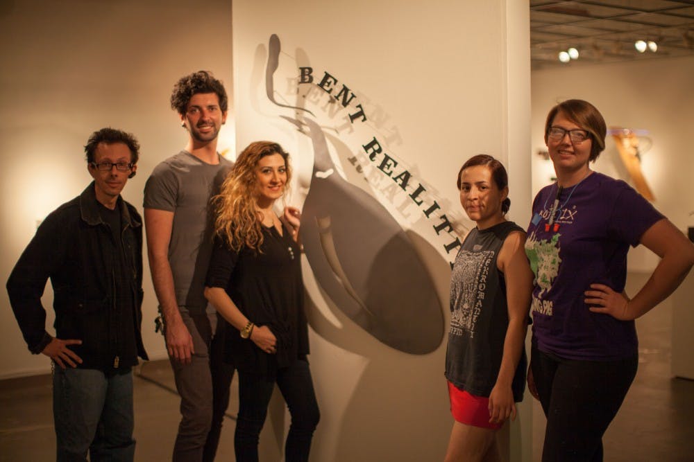 Spencer Brown, Gregory Simoncic, Roxana Derakhshani, Gabriela Gomez and Deidra West pose for a picture, Sunday in Tempe. The seniors are artists featured in the exhibition "Bent Realities," which opened Tuesday in Gallery 100 at the Tempe Center. (Jonathan Galan/ State Press)