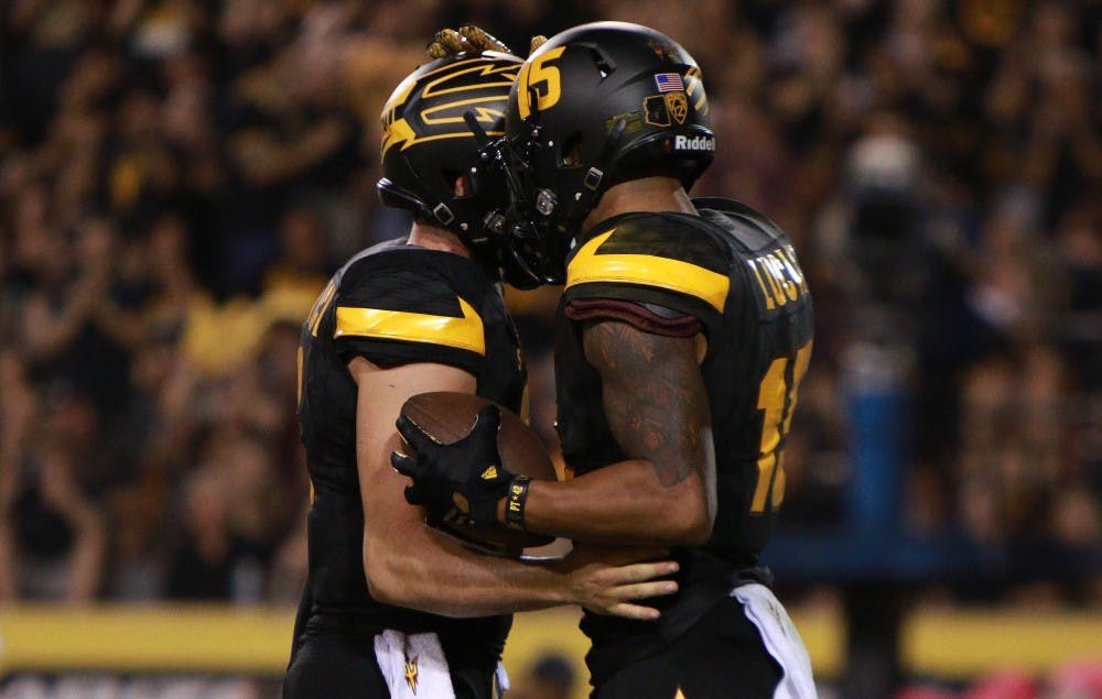 Redshirt senior wide receiver Devin Lucien (15) reacts with Redshirt senior quarter back Mike Bercovici (2) after a touchdown pass in the third quarter against Colorado on Saturday, Oct. 10, 2015, at Sun Devil Stadium in Tempe. The Sun Devils defeated the Buffaloes 48-23.