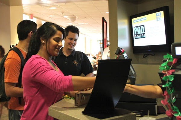 TIME TO EAT: Sophomore political science and psychology major, Faryal Mushtaq, swipes her Sun Card at the Memorial Union dining hall on the Tempe campus Tuesday night. (Photo by Rosie Gochnour)