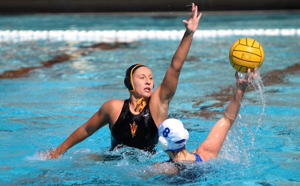 Sophomore center Liz Kreek extends her arm to deny a shot from a Hartwick defender. The ASU water polo team will take on Hartwick again this weekend in the Brown Tournament. (Photo by Dominic Valente)