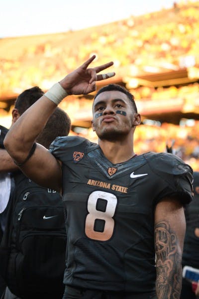 Junior running back D.J. Foster salutes fans with a pitchfork after the game against Notre Dame on Nov. 8, 2014. ASU defeated Notre Dame 55-31 at Sun Devil Stadium. (Photo by Andrew Ybanez)