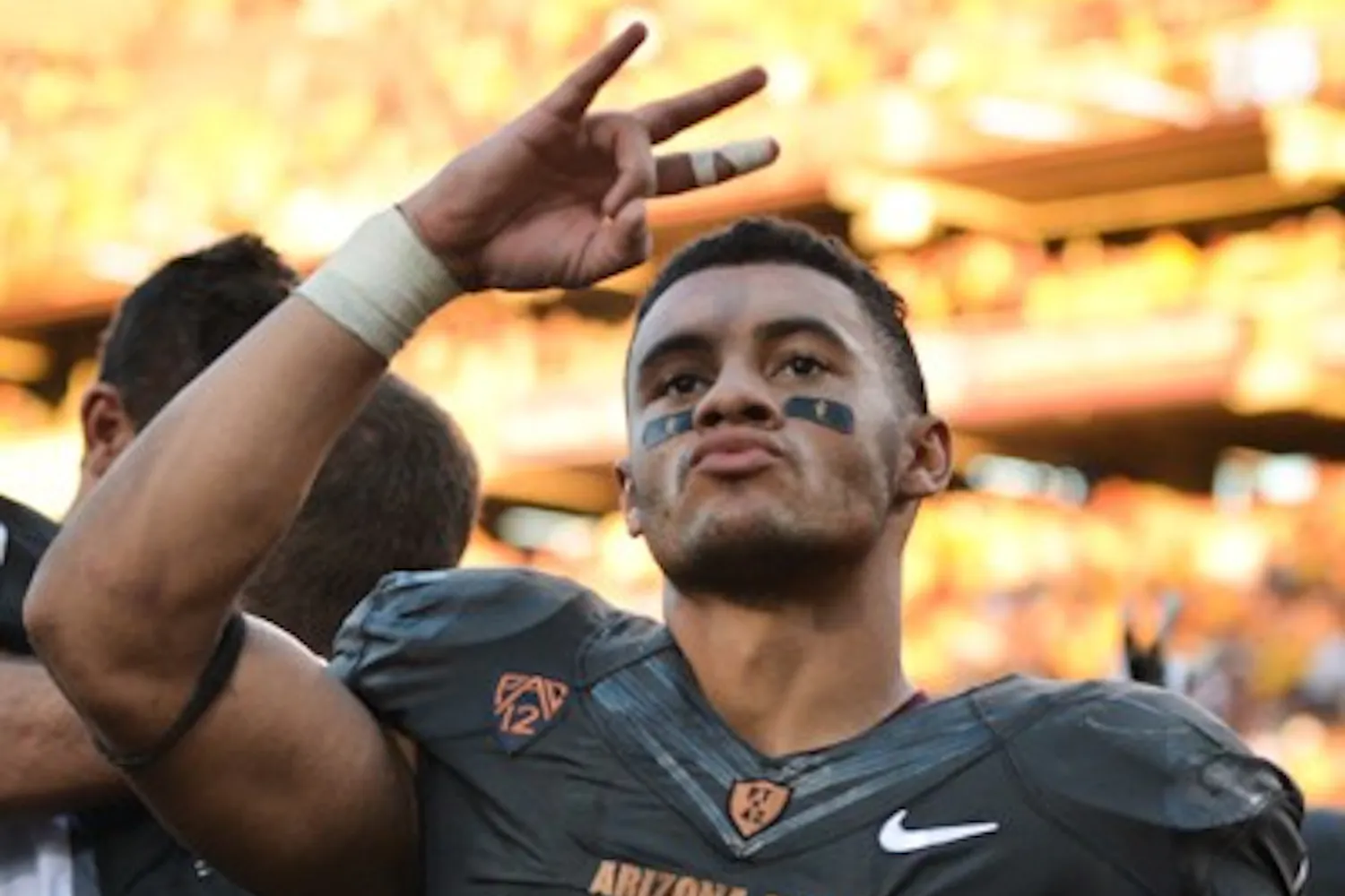 Junior running back D.J. Foster salutes fans with a pitchfork after the game against Notre Dame on Nov. 8, 2014. ASU defeated Notre Dame 55-31 at Sun Devil Stadium. (Photo by Andrew Ybanez)