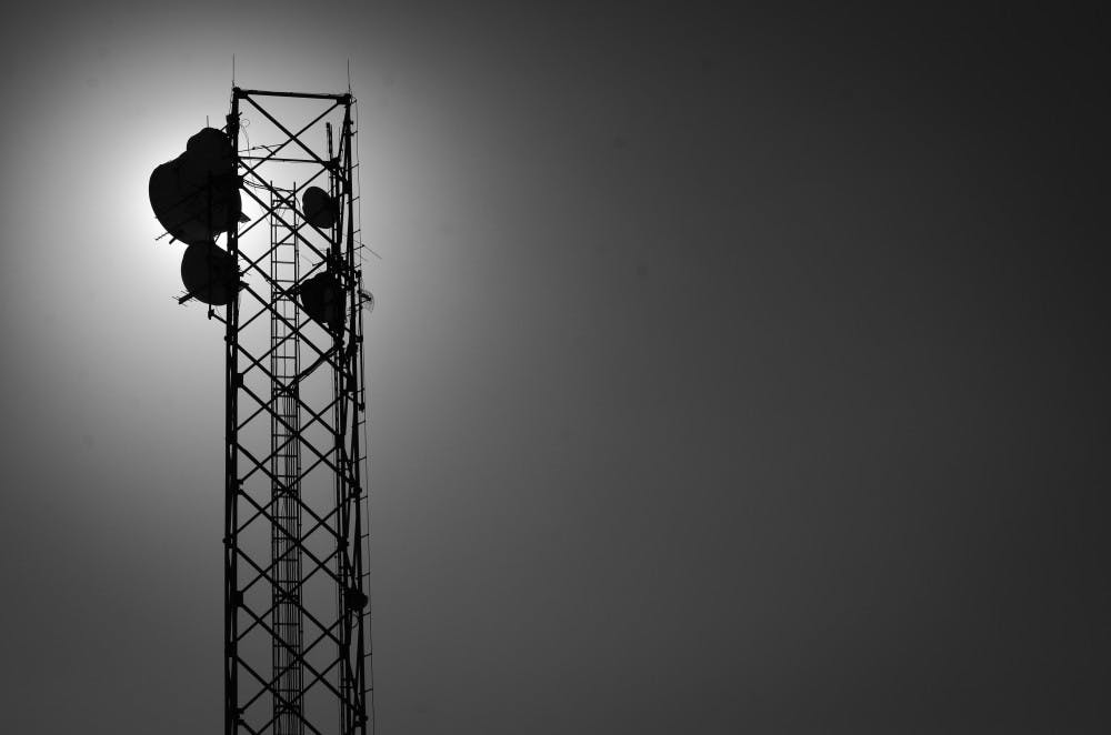 GROUND CONTROL: Sunlight pierces through a communication tower on Sunday near Lattie Coor Hall.  (Photo by Aaron Lavinsky)