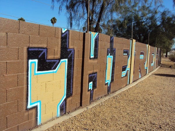 LEGAL ART: Businesses around downtown Phoenix are allowing graffiti artists to spray paint buildings and walls to express artistic talent in a legal way. (Photo Courtesy of Meghann McKendry)