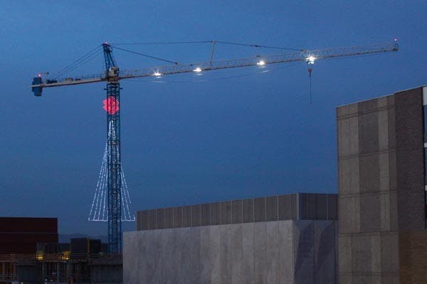 CHRISTMAS CRANE: A crane suspends a gigantic Christmas tree of lights, over an ASU construction sight between Rural Rd. and McCallister Ave. (Photo by Rosie Gochnour)