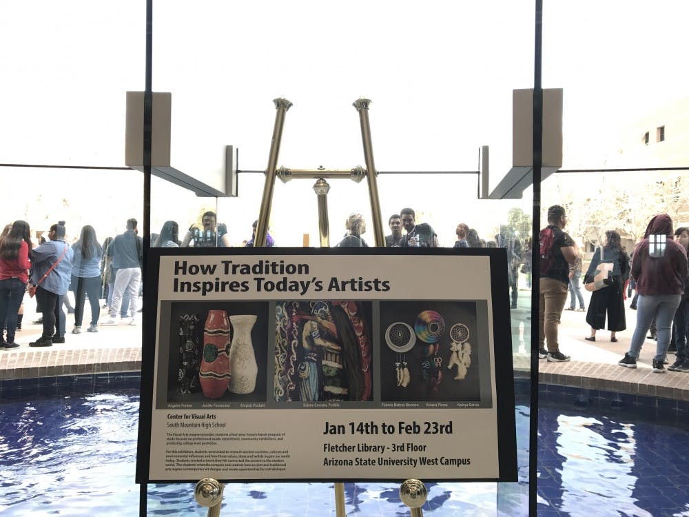 Artists and visitors gather in the Fletcher Library for "How Traditions Inspire Today's Artists" at the ASU West campus&nbsp;on Feb. 10, 2017. The exhibit displays the work of local students and artists.