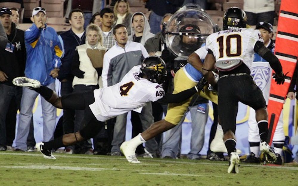 LUCKY DAY: Junior defensive end James Brooks attempts to sack Stanford redshirt sophomore quarterback Andrew Luck during Saturday's 17-13 ASU loss. The Sun Devils defense did not allow Luck to throw a touchdown, something he hasn't done all season. (Photo by Scott Stuk)