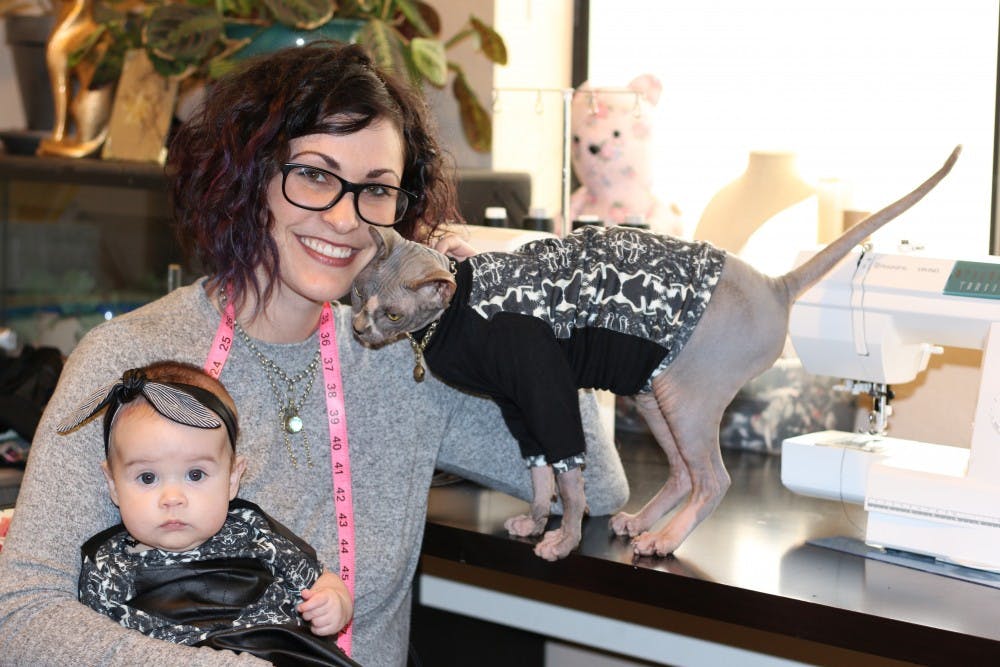 Jessica Kelley, a design student and the founder of the Haus of Miw line of matching&nbsp;clothing for babies and pets, pictured here with her&nbsp; daughter and cat.