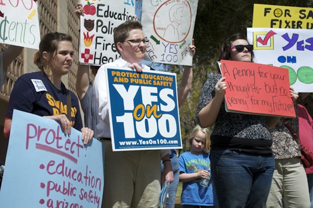 ASA MEMBERS: Junior political science major and ASA intern Sarah Baine (left) and senior integrated studies major and ASA government affairs intern Ashley Wilcox (right) stand outside the Phoenix capitol building to support the passing of Proposition 100 last month. (Photo by Molly Smith)