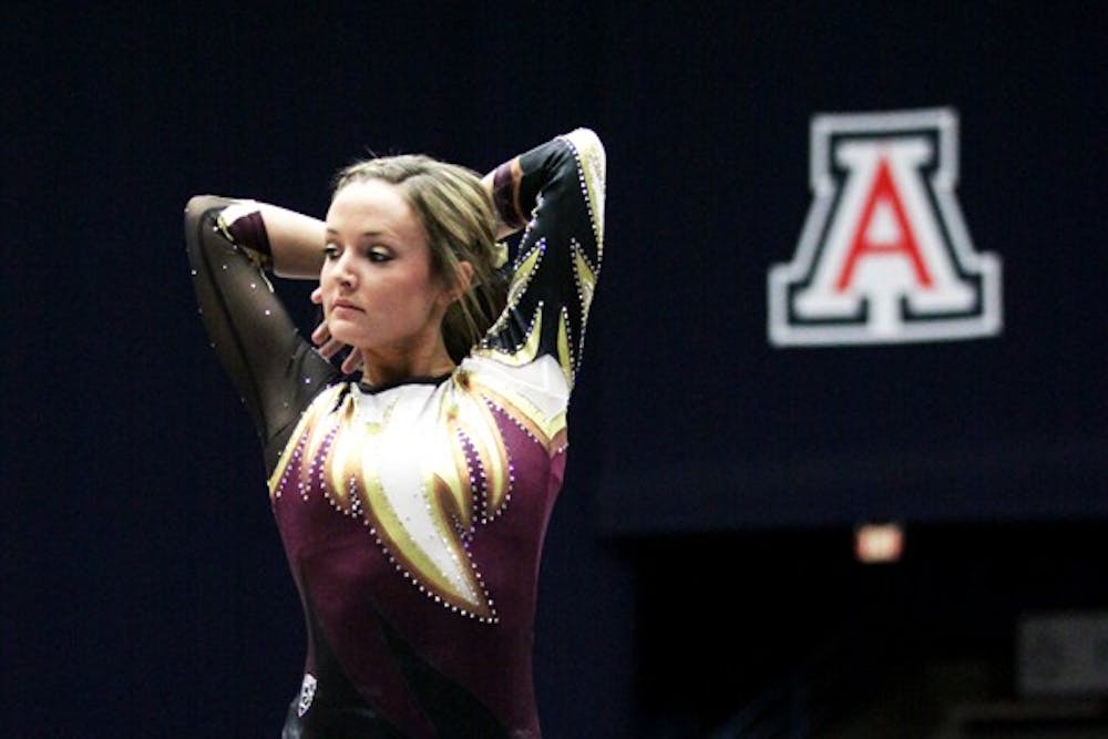 Sophomore Brianna Gades finishes her routine by striking a pose against UA on March 2. The gymnastics team hopes to strike a strong score in the Pac-12 championships. (Photo by Arianna Grainey)