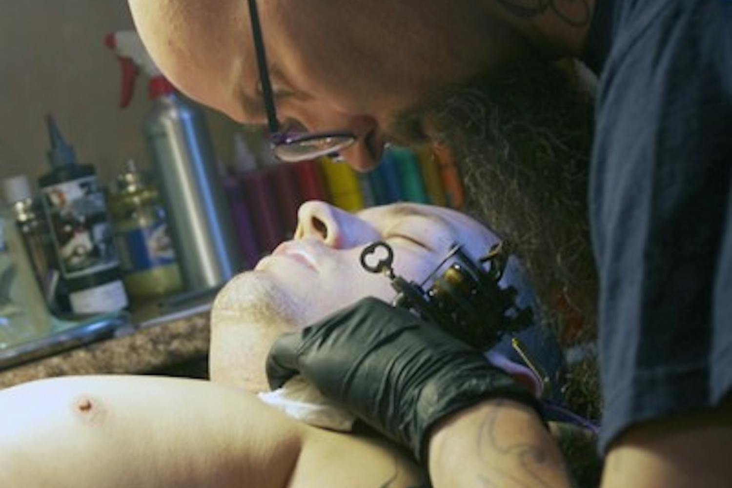 FREE SPEECH ART: Nathan Rios gets a tattoo done across his chest by Living Canvas Tattoo artist, Chris Parrish. The issue of whether tattoos are protected under the First Amendment right of freedom of speech has long been debated by Constitutional experts. (Photo by Shawn Raymundo)