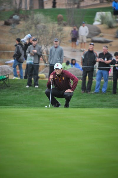 Junior Jon Rahm studies the green at the 9th hole at the 2015 WM Phoenix Open on Jan. 30, 2015. (Andrew Ybanez/The State Press)