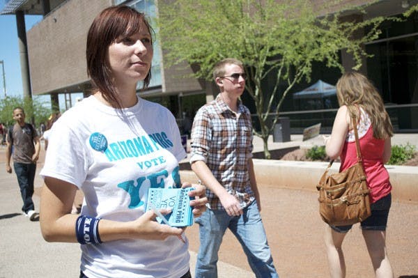 PIRG: An employee for PIRG, who declined to give her name, encourages students on the Downtown campus to vote for PIRG in the Tuesday and Wednesday student government elections. (Photo by Molly Smith)