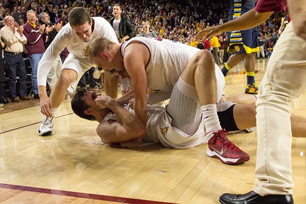 Senior center Jordan Bachynski and his teammates celebrate after a victory over Marquett Monday, Nov. 25 at Wells Fargo Arena. (Photo by Vince Dwyer)