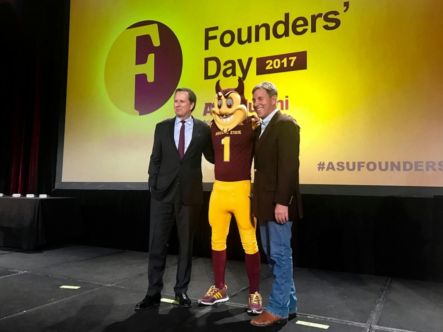 Award recipients&nbsp;Michael Burns and Jack Furst pose with Sparky on Founders' Day 2017.