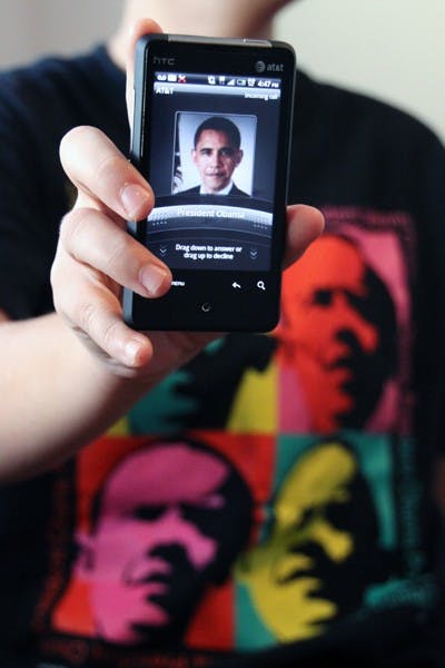 PRESIDENT CALLING: A student poses for a picture depicting a phone call from President Barack Obama. Youth reporters around the nation had a conference call with President Obama Monday afternoon. (Photo by Rosie Gochnour)