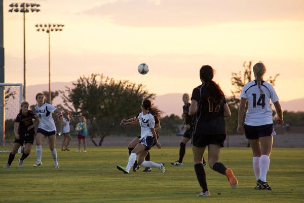 ASU and NAU scramble for a loose ball in a scrimmage on Aug. 15 at West Campus. 