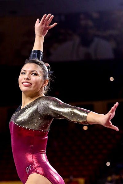Sophomore Allie Salas stikes a pose during her floor routine at the the first home meet. (Photo courtesy of Arianna Grainey)