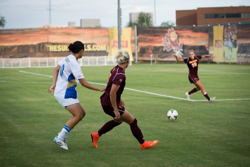 Junior defender McKenzie Berryhill passes the ball to sophomore defender Mckenzie Grossman during the game against UCLA on Sept. 26 in Tempe. (Photo by Andrew Ybanez)