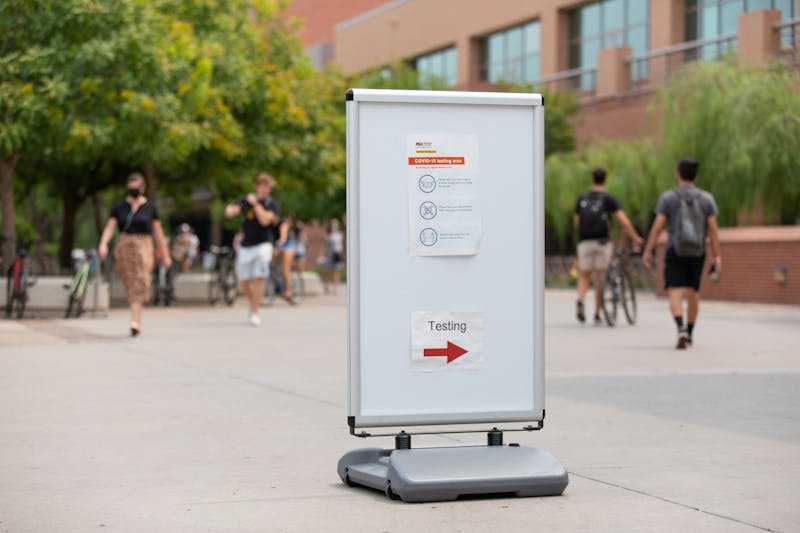 ASU students walk past the COVID testing area by the SDFC Maroon Gym on the Tempe Campus, in Tempe, Arizona on Wednesday, August 26, 2020.