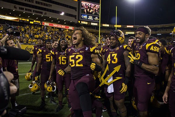 Redshirt junior Carl Bradford celebrates the ASU win against Washington 53-24. (Photo by Diana Lustig)