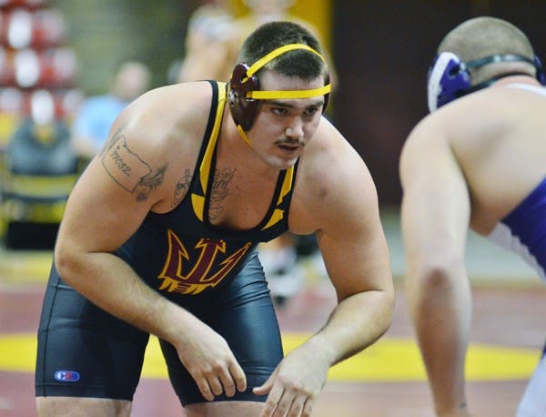 ASU senior Levi Cooper faces off against Grand Canyon’s Jordan Johnson on Nov. 13. Cooper upset returning national champion Zach Rey from No. 10 Lehigh during the Sun Devils successful weekend at the Northeast Duals. (Photo by Aaron Lavinsky)