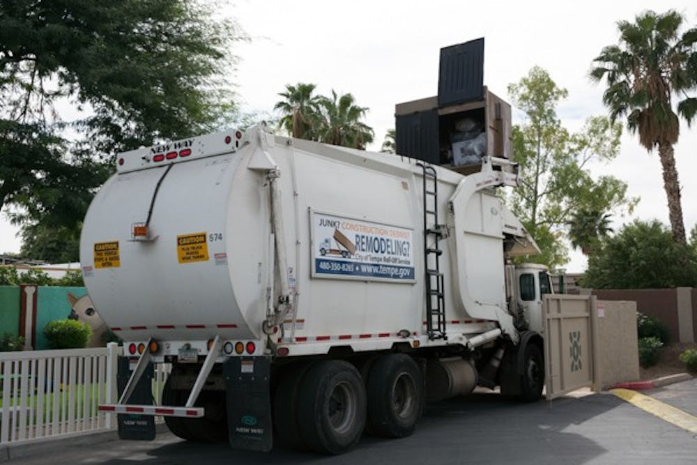 A local waste removal truck makes its rounds Monday morning in Tempe, Arizona. (Photo by Carly Traxler)