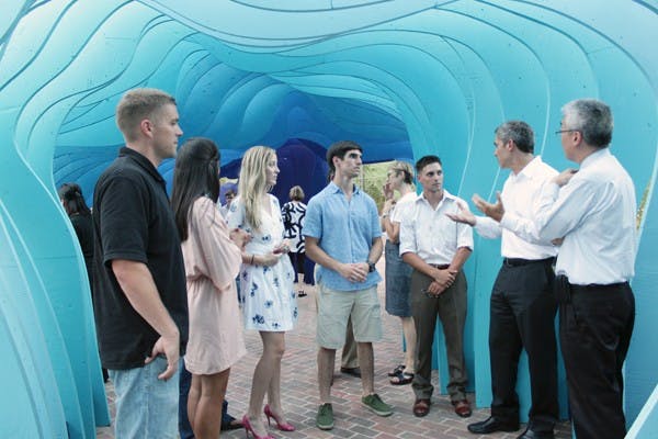 FINISHED PRODUCT: The winners of the art contest are congratulated by the Director of The Design School Darren Petrucci, left, and the Dean and Director of the Herberger Institute of Design and the Arts Kwang-Wu Kim, right. The students spent nearly four months constructing the structure. (Photo by Beth Easterbrook)