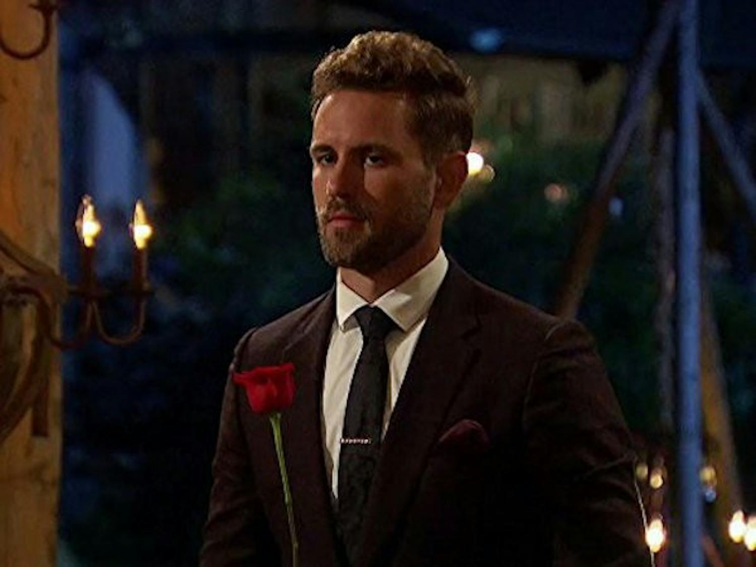 Current Bachelor Nick Viall holds a rose during an episode of The Bachelor.