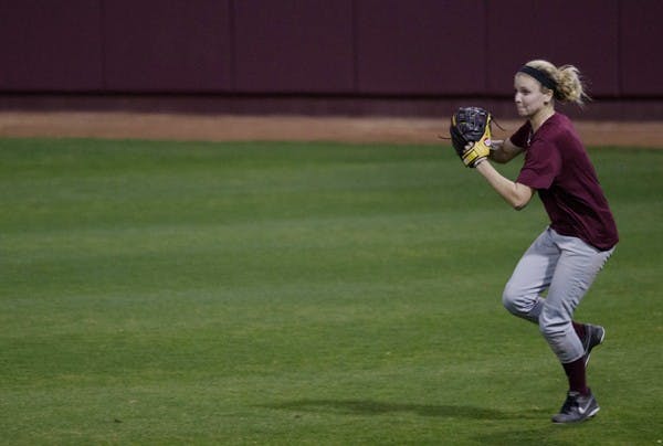 An ASU softball outfielder gathers her feet to throw the ball from the outfield to cutoff an infielder during practice on Feb. 8. (Photo by Dominic Valente)