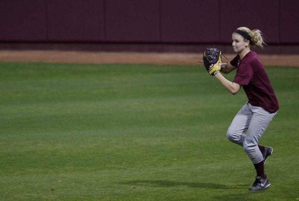 An ASU softball outfielder gathers her feet to throw the ball from the outfield to cutoff an infielder during practice on Feb. 8. (Photo by Dominic Valente)